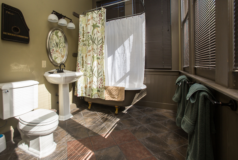 A bathroom with a toilet, sink, and shower.