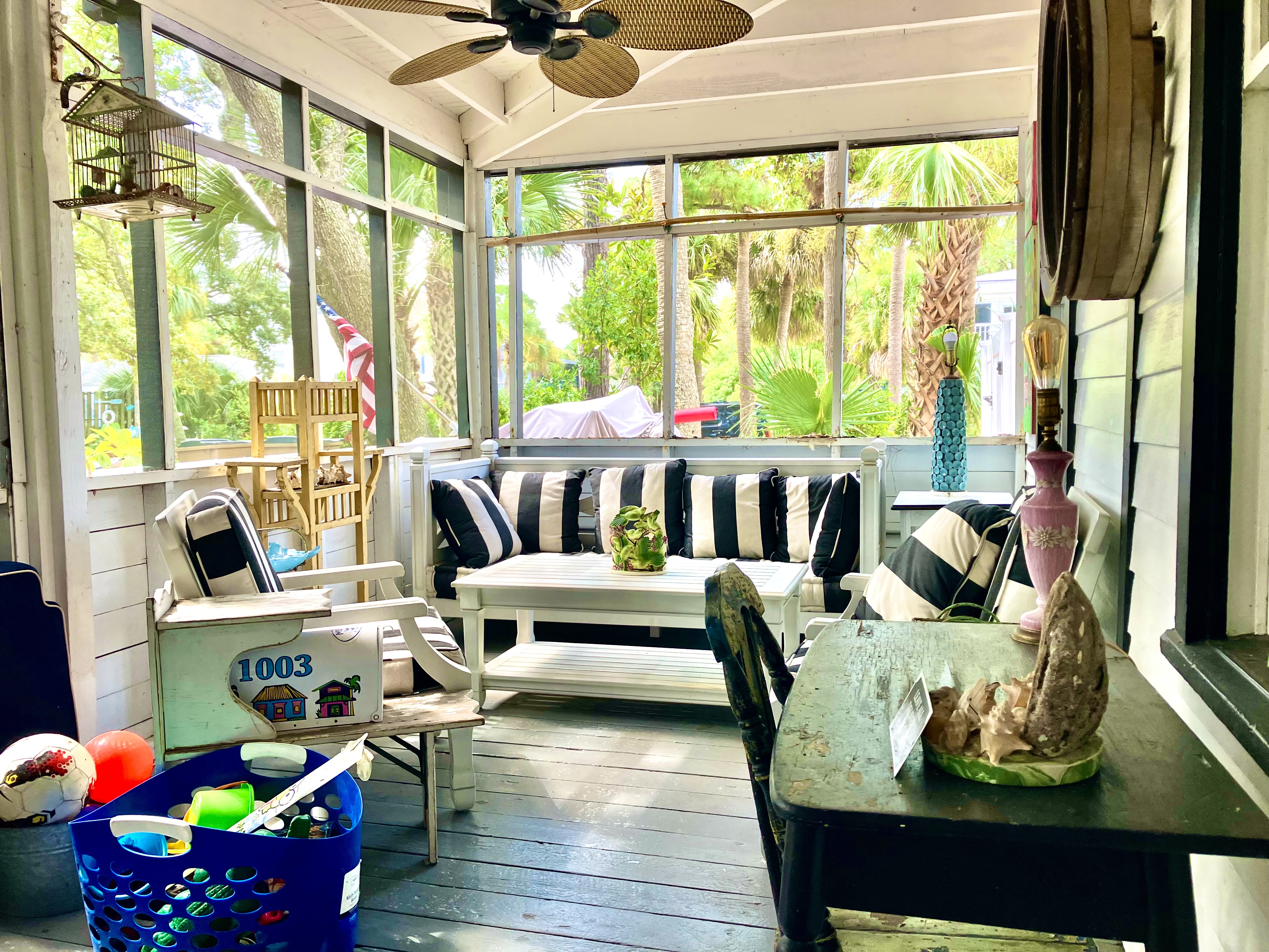 Large screened porch, with sofa and swing.