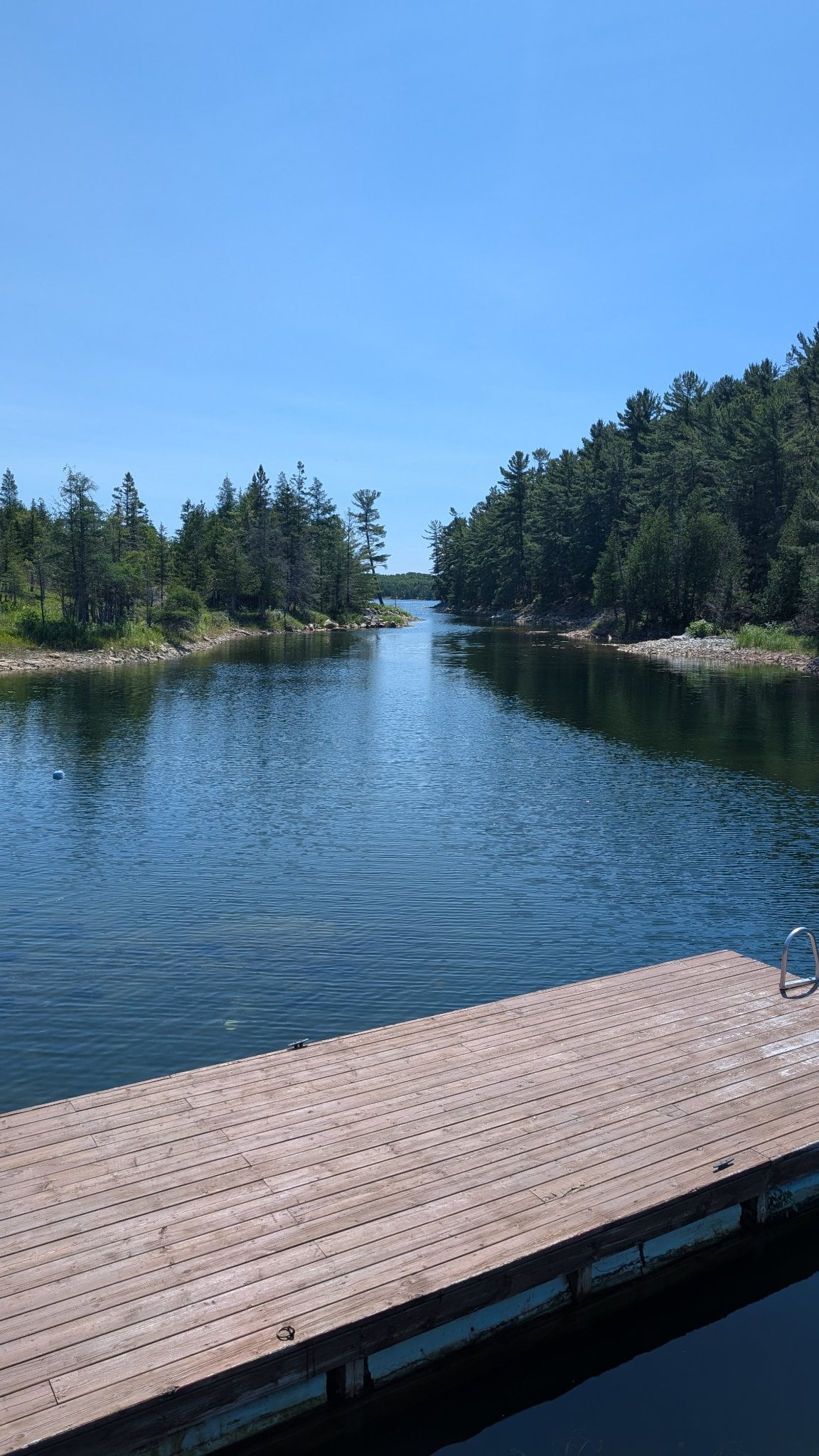 Crystal clear river channel from the dock — perfect for swimming and exploring
